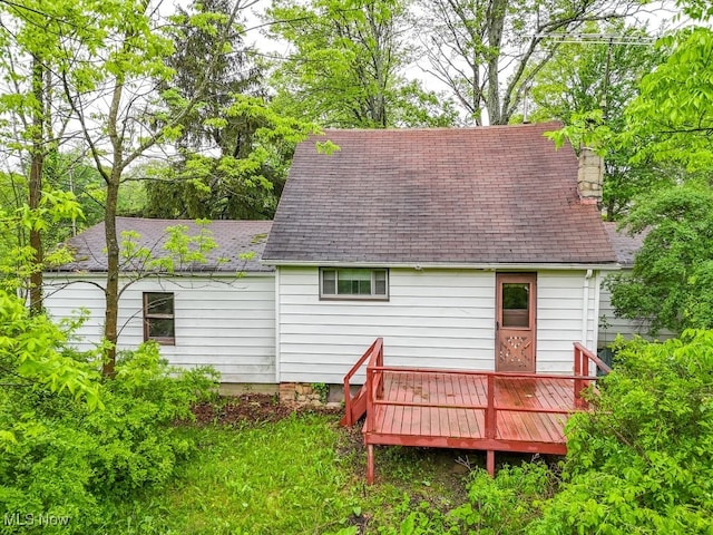 14721 Zenith Dr, Newbury, OH 44065 - back of house with a deck, roof with shingles, and a chimney