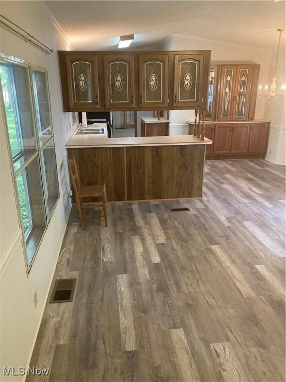 1229 Columbiana Lisbon Rd Unit 39, Columbiana, OH 44408 - kitchen featuring wood finished floors, plenty of natural light, a chandelier, baseboards, and crown molding