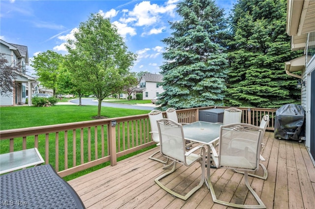 6811 Meadow Ln, Cleveland, OH 44130 - deck with outdoor dining area, a lawn, and a grill