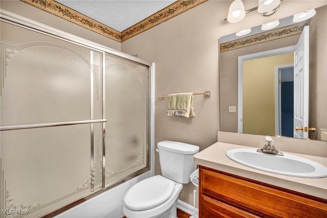 6811 Meadow Ln, Cleveland, OH 44130 - full bathroom featuring vanity, toilet, and bath / shower combo with glass door