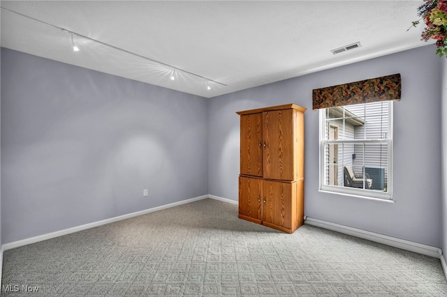 6811 Meadow Ln, Cleveland, OH 44130 - spare room featuring track lighting, carpet flooring, and baseboards