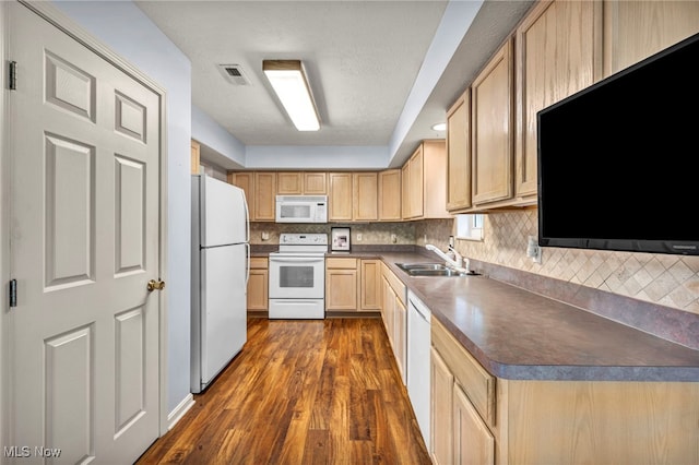6811 Meadow Ln, Cleveland, OH 44130 - kitchen featuring white appliances, a sink, light brown cabinetry, dark wood-style floors, and dark countertops