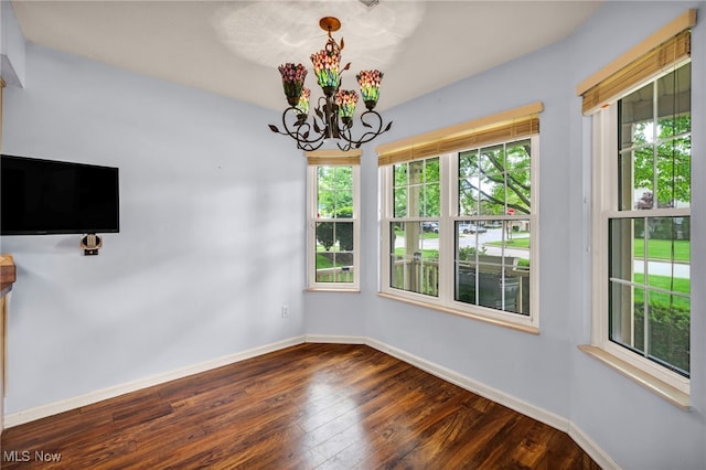 6811 Meadow Ln, Cleveland, OH 44130 - unfurnished dining area featuring dark wood finished floors, baseboards, and a chandelier