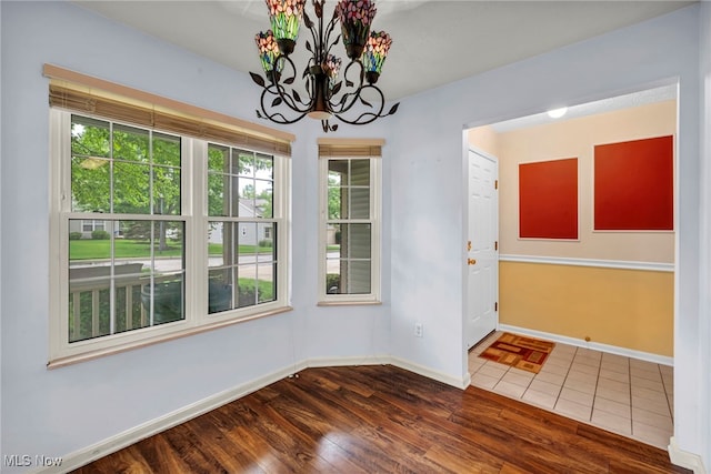 6811 Meadow Ln, Cleveland, OH 44130 - unfurnished dining area with wood finished floors, a chandelier, and baseboards
