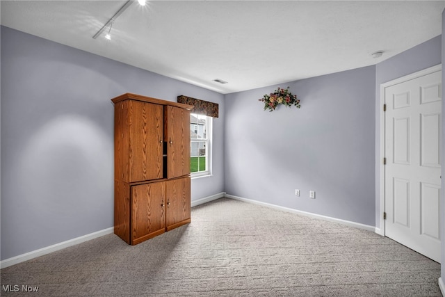 6811 Meadow Ln, Cleveland, OH 44130 - carpeted spare room featuring rail lighting and baseboards