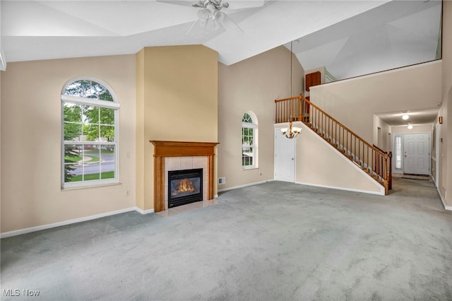 6811 Meadow Ln, Cleveland, OH 44130 - unfurnished living room with a ceiling fan, stairway, high vaulted ceiling, carpet, and a tile fireplace
