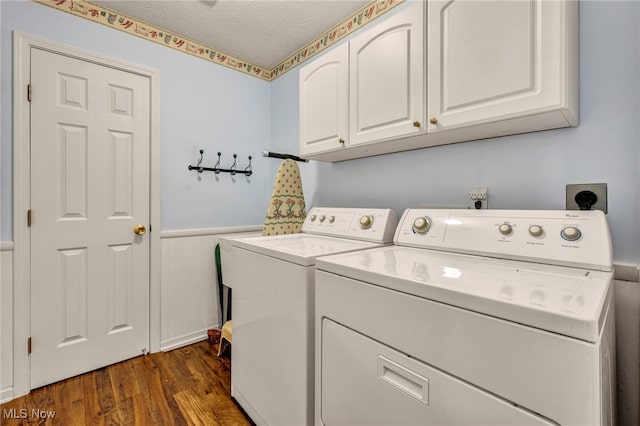 6811 Meadow Ln, Cleveland, OH 44130 - laundry room featuring cabinet space, washing machine and dryer, wainscoting, dark wood-style floors, and a textured ceiling