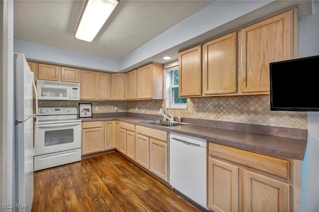 6811 Meadow Ln, Cleveland, OH 44130 - kitchen with white appliances, a sink, light brown cabinetry, dark countertops, and dark wood-type flooring