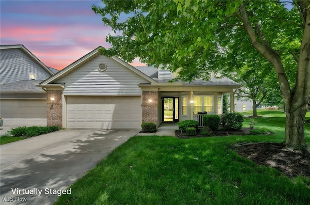6811 Meadow Ln, Cleveland, OH 44130 - view of front of property featuring a garage, concrete driveway, a front yard, and brick siding