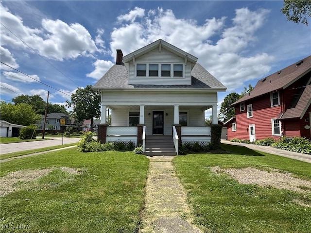 328 S Canal St, Newton Falls, OH 44444 - view of front of house featuring a porch, a front yard, a shingled roof, and a chimney