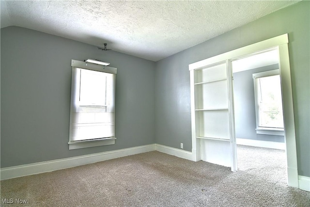 1033 Monnot Pl NW, Canton, OH 44703 - spare room featuring carpet, a textured ceiling, and baseboards