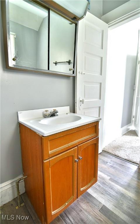 1033 Monnot Pl NW, Canton, OH 44703 - bathroom featuring vanity and wood finished floors