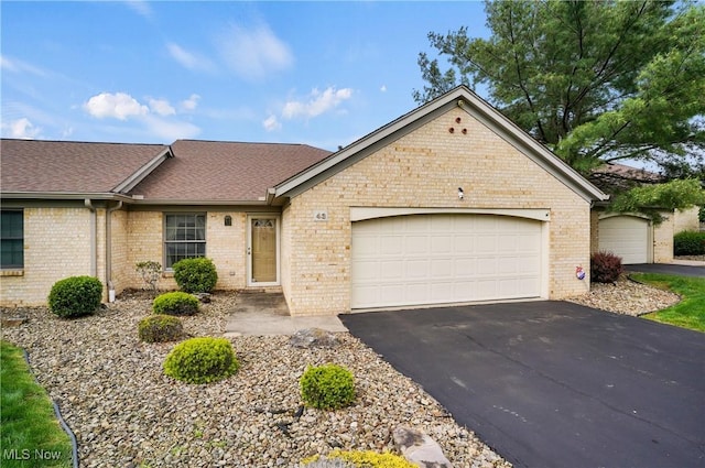 820 Southwestern Run Unit 43, Poland, OH 44514 - single story home featuring brick siding, driveway, an attached garage, and a shingled roof