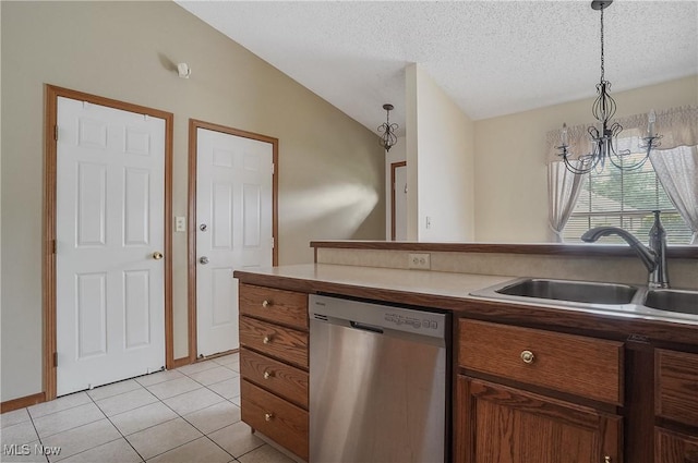 820 Southwestern Run Unit 43, Poland, OH 44514 - kitchen with stainless steel dishwasher, a sink, a chandelier, vaulted ceiling, and hanging light fixtures