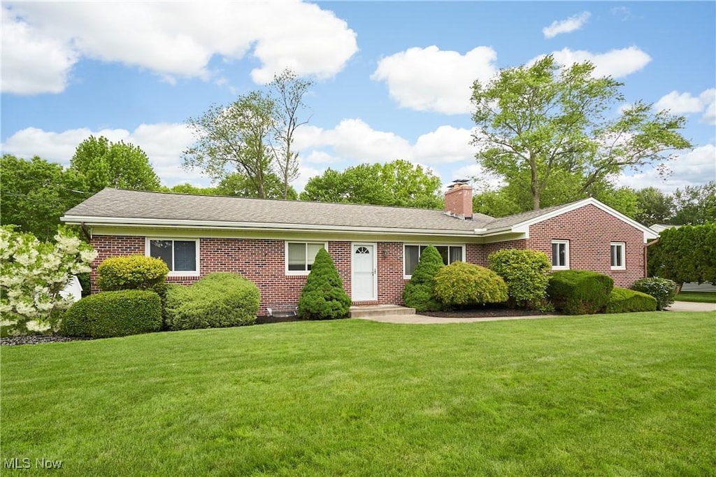 206 Benson Rd, Akron, OH 44333 - ranch-style house with a chimney, a front lawn, and brick siding