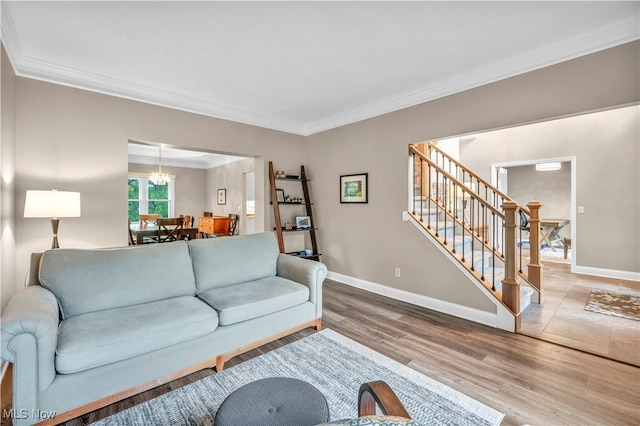 17360 Woodlawn Ct, Strongsville, OH 44149 - living room featuring ornamental molding, wood finished floors, stairs, baseboards, and a chandelier