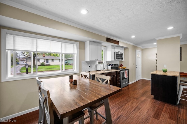 6270 Springwood Rd, Parma Heights, OH 44130 - dining space featuring ornamental molding, baseboards, recessed lighting, dark wood-style floors, and a textured ceiling
