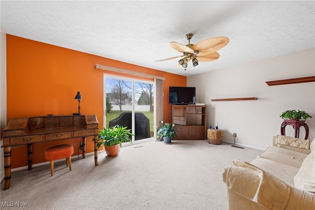 6874 Stratford Cir Unit D, Mentor, OH 44060 - living room featuring a ceiling fan, carpet, a textured ceiling, and baseboards