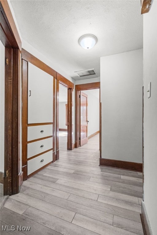1023 Fulton Rd NW, Canton, OH 44703 - corridor featuring light wood-type flooring, baseboards, and a textured ceiling