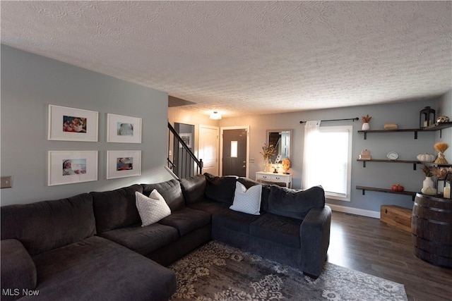 10957 Mogadore Ave NW, Uniontown, OH 44685 - living area with a textured ceiling, wood finished floors, stairway, and baseboards