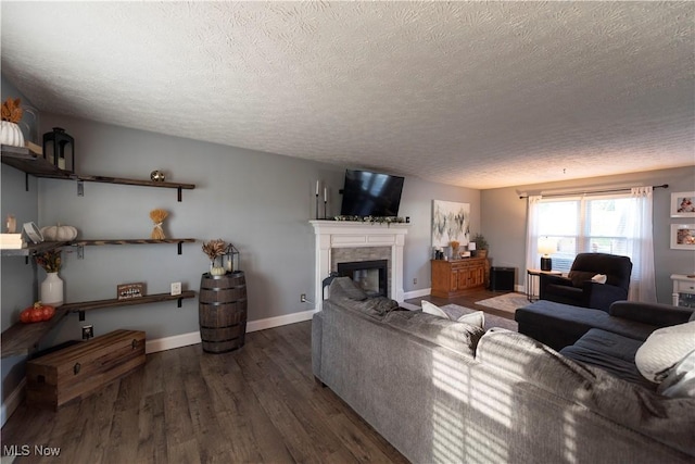 10957 Mogadore Ave NW, Uniontown, OH 44685 - living area with a textured ceiling, wood finished floors, a fireplace, and baseboards