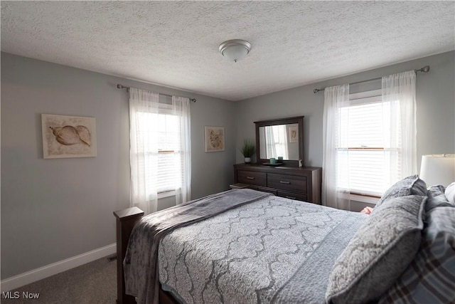 10957 Mogadore Ave NW, Uniontown, OH 44685 - carpeted bedroom featuring baseboards and a textured ceiling