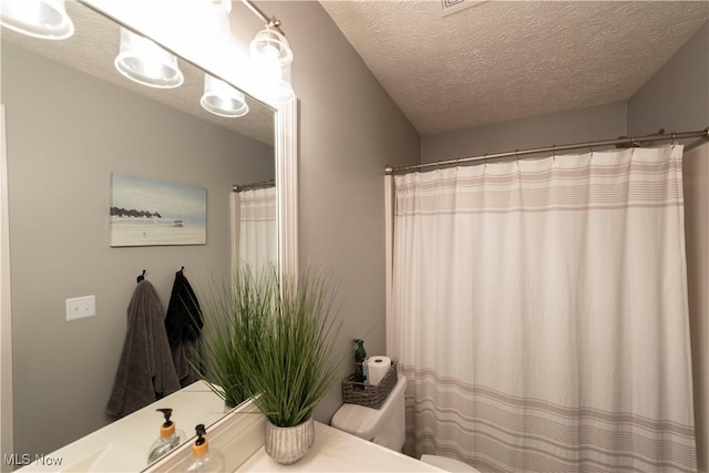 10957 Mogadore Ave NW, Uniontown, OH 44685 - full bathroom with vanity, a textured ceiling, toilet, and curtained shower