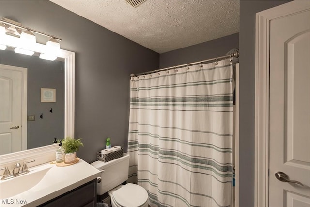 10957 Mogadore Ave NW, Uniontown, OH 44685 - full bath featuring vanity, toilet, a textured ceiling, and a shower with shower curtain