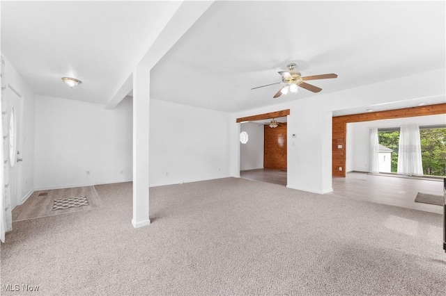 703 Annapolis Ave, Akron, OH 44310 - unfurnished living room featuring carpet flooring, a ceiling fan, and baseboards