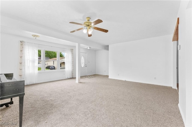 703 Annapolis Ave, Akron, OH 44310 - unfurnished living room with a ceiling fan, carpet, and baseboards