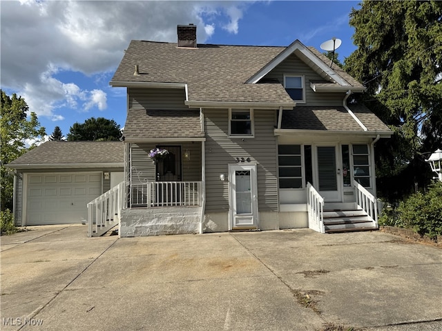 324 The Brooklands, Akron, OH 44305 - tri-level home with concrete driveway, a chimney, a shingled roof, covered porch, and a garage