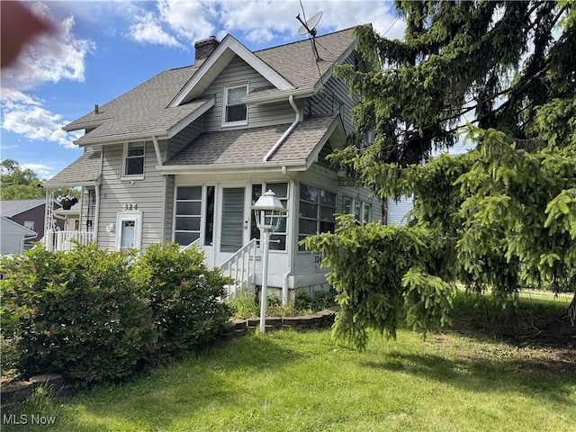 324 The Brooklands, Akron, OH 44305 - view of front of property featuring a shingled roof, a chimney, and a front yard