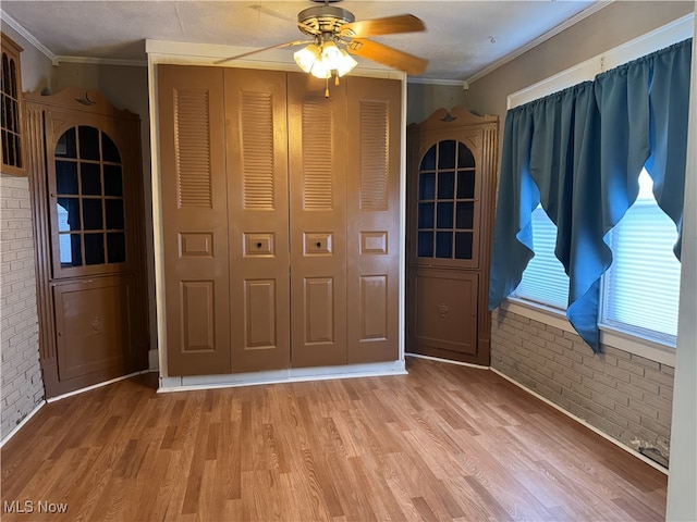 324 The Brooklands, Akron, OH 44305 - foyer with brick wall, a ceiling fan, light wood-style floors, and ornamental molding