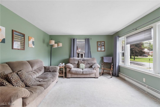 174 Woolf Ave, Akron, OH 44312 - carpeted living room with a baseboard heating unit and healthy amount of natural light