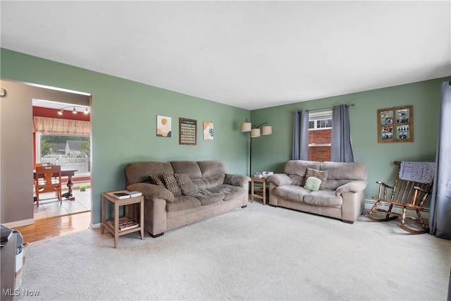 174 Woolf Ave, Akron, OH 44312 - living area with plenty of natural light, carpet flooring, and baseboard heating