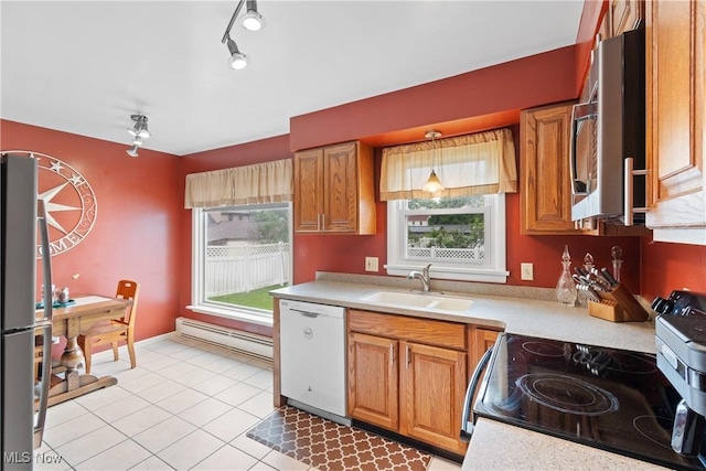 174 Woolf Ave, Akron, OH 44312 - kitchen with stainless steel appliances, a sink, a baseboard heating unit, light countertops, and light tile patterned flooring