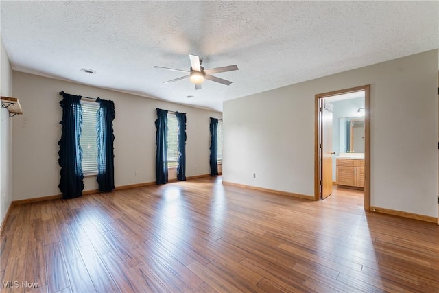 1820 Schneider St NW, North Canton, OH 44720 - unfurnished room featuring a ceiling fan, a textured ceiling, light wood-style flooring, and baseboards