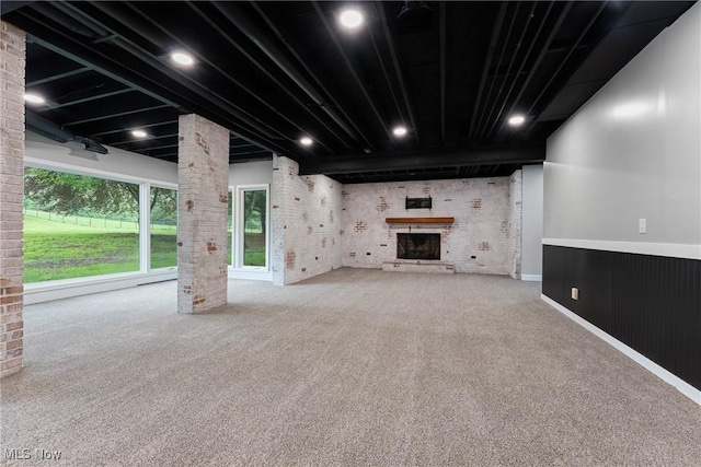 1820 Schneider St NW, North Canton, OH 44720 - below grade area featuring brick wall, carpet, and a brick fireplace