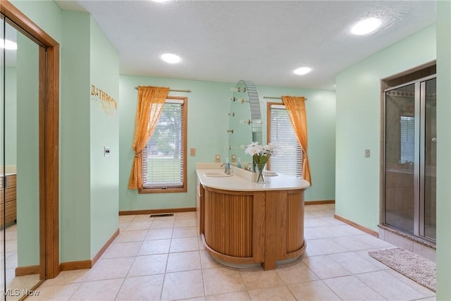 1820 Schneider St NW, North Canton, OH 44720 - full bathroom with a stall shower, double vanity, baseboards, tile patterned flooring, and recessed lighting