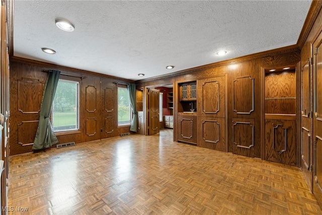 1820 Schneider St NW, North Canton, OH 44720 - spare room with wooden walls, ornamental molding, and a textured ceiling