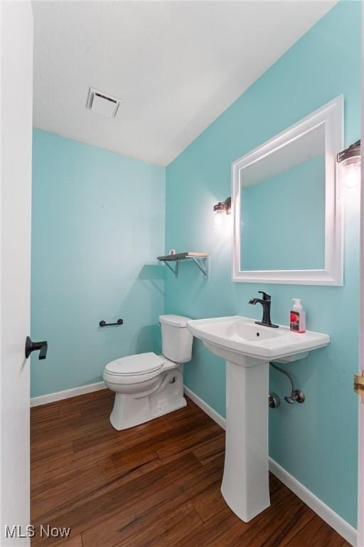 1820 Schneider St NW, North Canton, OH 44720 - half bath featuring toilet, wood finished floors, and baseboards