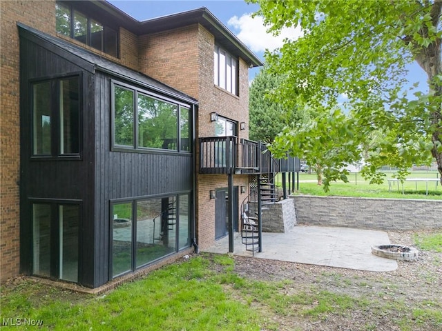 1820 Schneider St NW, North Canton, OH 44720 - back of house with stairs, a patio area, a wooden deck, and brick siding