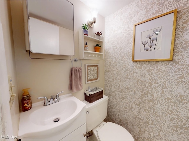 1651 Mentor Ave Unit 3002, Painesville, OH 44077 - bathroom featuring wallpapered walls, toilet, and vanity