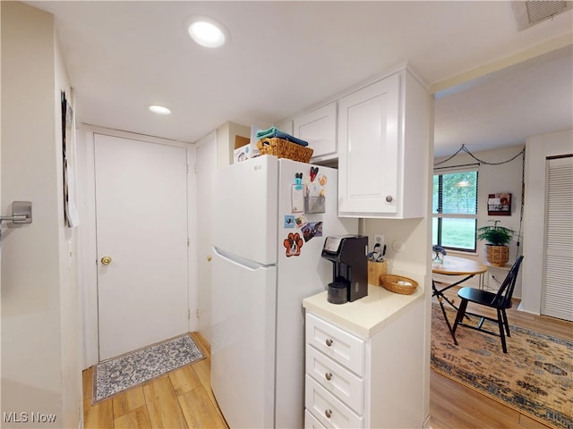1651 Mentor Ave Unit 3002, Painesville, OH 44077 - kitchen featuring freestanding refrigerator, light wood-type flooring, white cabinets, light countertops, and recessed lighting