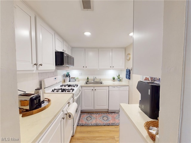 1651 Mentor Ave Unit 3002, Painesville, OH 44077 - kitchen with white appliances, a sink, white cabinets, light wood finished floors, and recessed lighting