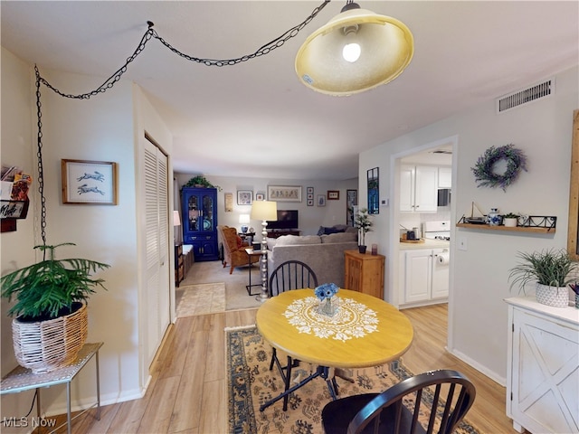 1651 Mentor Ave Unit 3002, Painesville, OH 44077 - dining space with light wood-style floors and baseboards