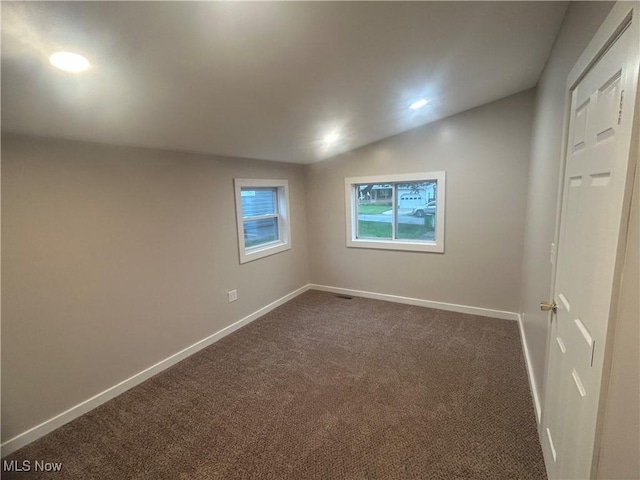 1706 Adams St, Coshocton, OH 43812 - unfurnished room featuring dark carpet, baseboards, lofted ceiling, and recessed lighting