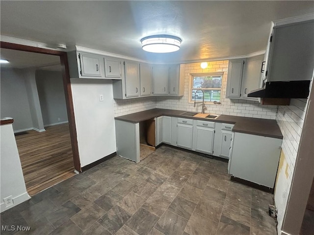 1706 Adams St, Coshocton, OH 43812 - kitchen with dark countertops, a sink, backsplash, and baseboards