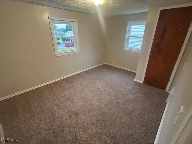 1706 Adams St, Coshocton, OH 43812 - unfurnished bedroom with a textured ceiling, carpet flooring, baseboards, and a closet