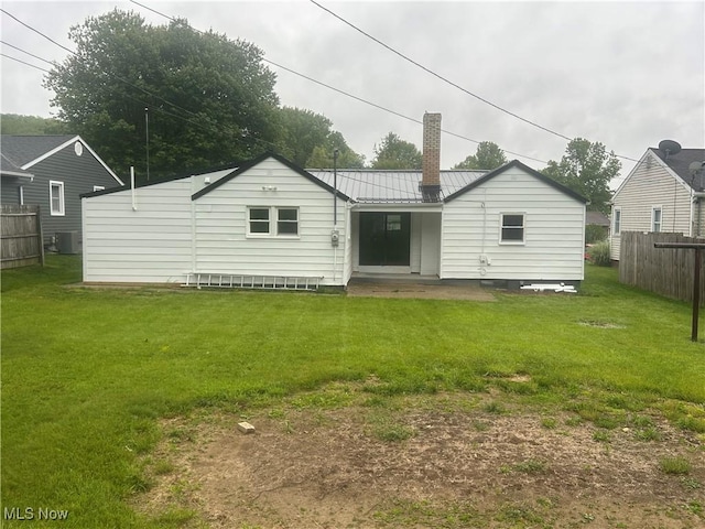 1706 Adams St, Coshocton, OH 43812 - rear view of house with central AC, a chimney, and metal roof